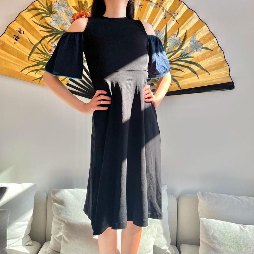 black ganni midi dress with blue ruffle sleeves
